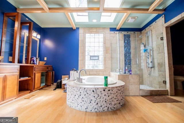 full bathroom featuring a shower stall, beamed ceiling, a garden tub, wood finished floors, and vanity