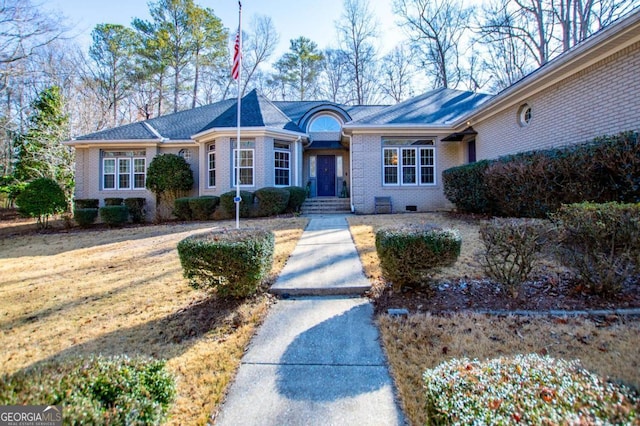 ranch-style home featuring brick siding