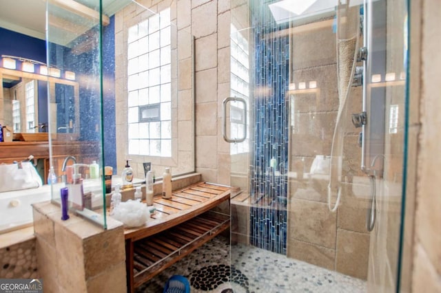 full bath featuring a shower stall, a skylight, and ornamental molding