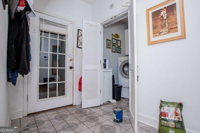 washroom featuring tile patterned floors, laundry area, washer / dryer, and visible vents