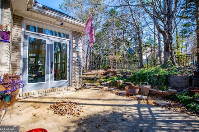 view of patio with french doors and fence