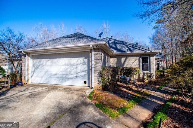 ranch-style home with concrete driveway, an attached garage, and brick siding