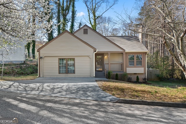 view of front of home featuring crawl space, driveway, and fence