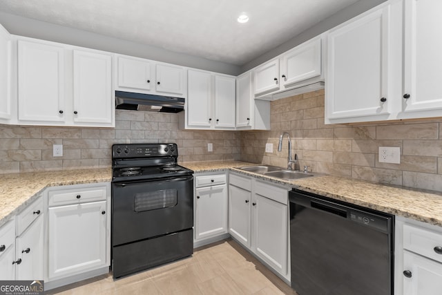 kitchen featuring under cabinet range hood, white cabinetry, black appliances, and a sink