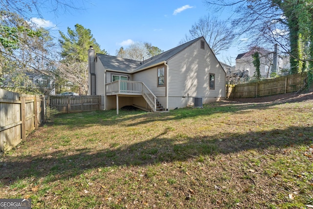 rear view of property with a yard, a fenced backyard, central AC, stairs, and a deck