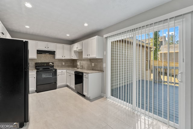 kitchen with decorative backsplash, black appliances, light stone countertops, and under cabinet range hood