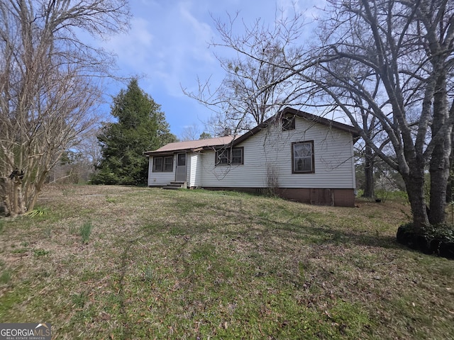 exterior space featuring a front yard and entry steps