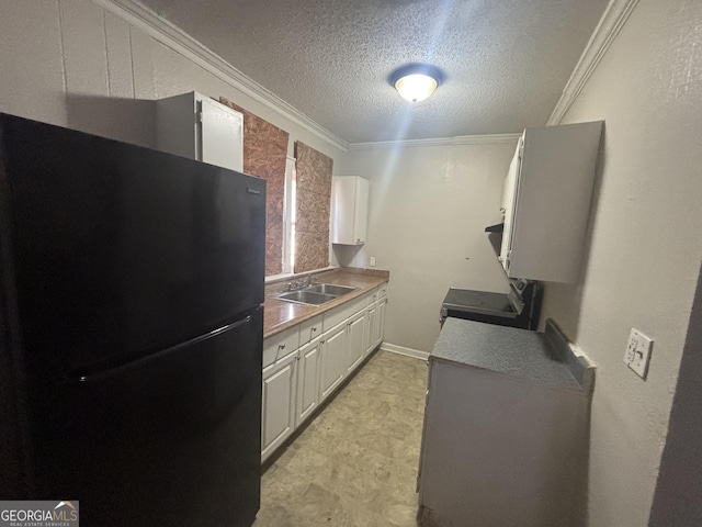 80 Harlan Rd SW, Atlanta, GA 30311 - kitchen with freestanding refrigerator, a textured ceiling, crown molding, and white cabinets