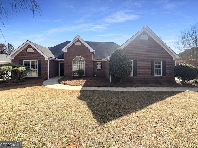 view of front of property with brick siding and a front lawn