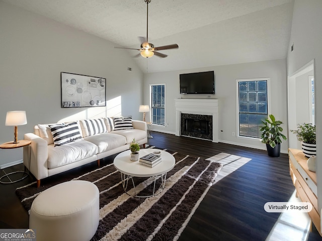 living room featuring wood finished floors, baseboards, a premium fireplace, lofted ceiling, and ceiling fan