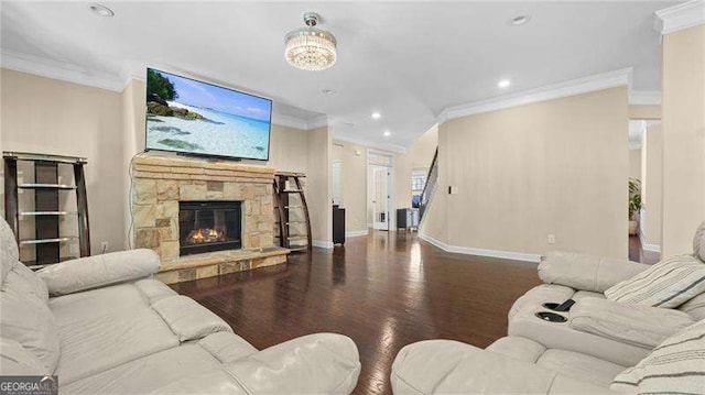 living area featuring baseboards, a fireplace, wood finished floors, and crown molding