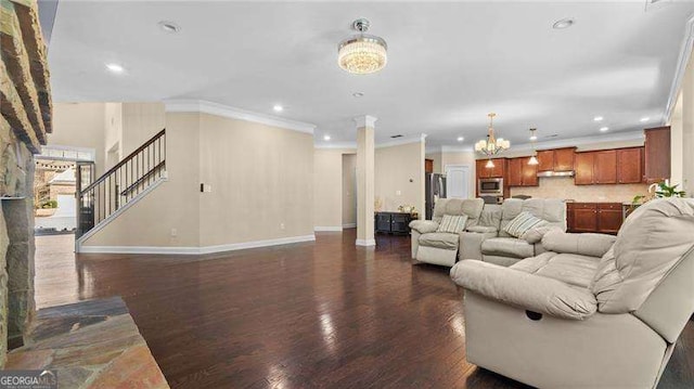 living area featuring baseboards, recessed lighting, ornamental molding, dark wood-type flooring, and a chandelier