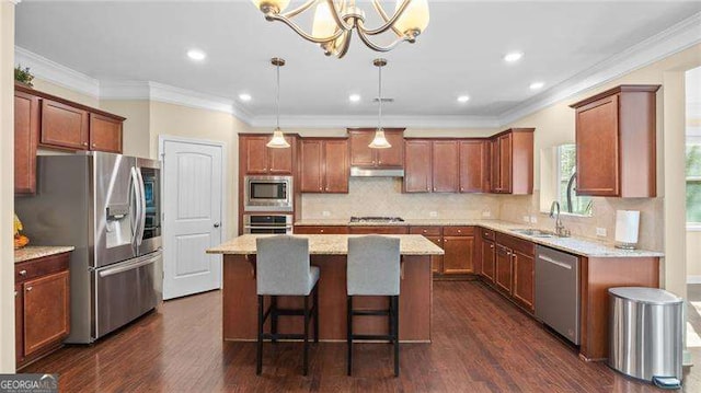 kitchen with dark wood-style floors, a sink, stainless steel appliances, under cabinet range hood, and a center island