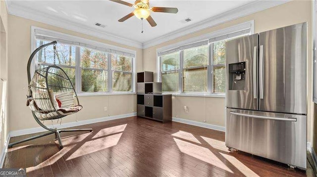 sitting room featuring dark wood finished floors, plenty of natural light, visible vents, and ornamental molding