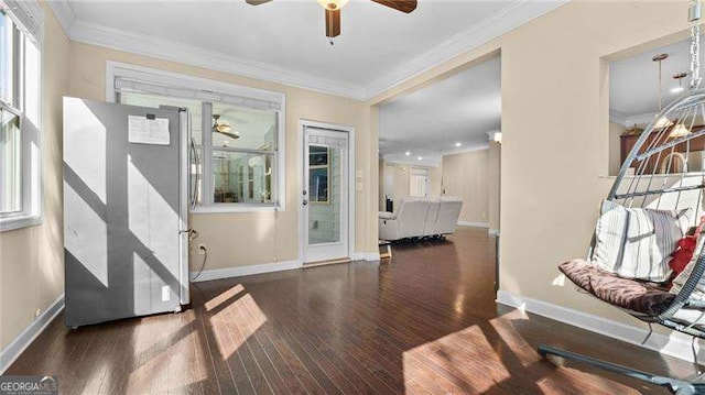 entrance foyer featuring crown molding, wood finished floors, baseboards, and ceiling fan