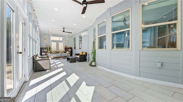 sunroom with french doors and a ceiling fan