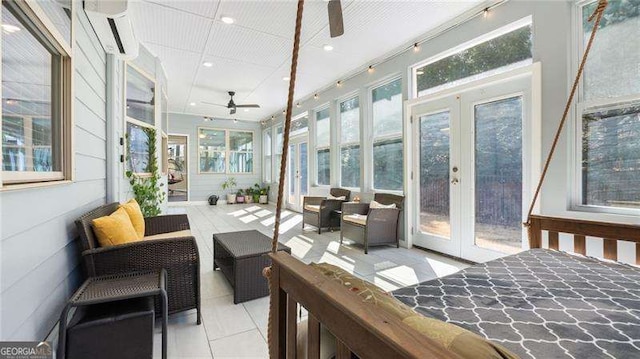 sunroom with a wall mounted air conditioner, french doors, and ceiling fan