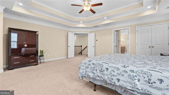 bedroom featuring baseboards, a raised ceiling, light carpet, and crown molding