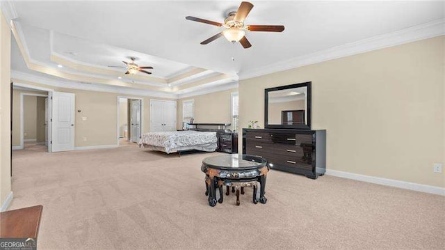 bedroom with a tray ceiling, baseboards, light colored carpet, and crown molding