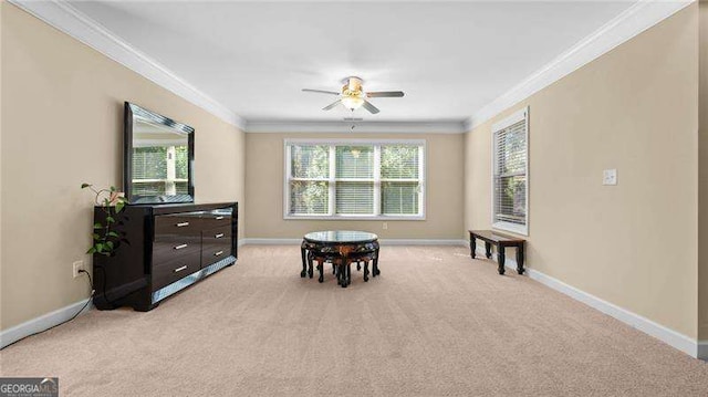 sitting room featuring ceiling fan, baseboards, and ornamental molding