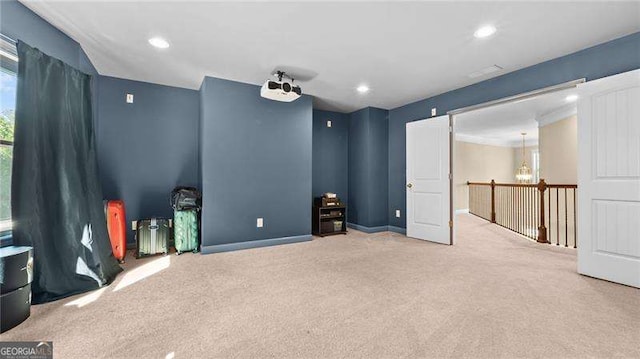 carpeted cinema with recessed lighting and a chandelier