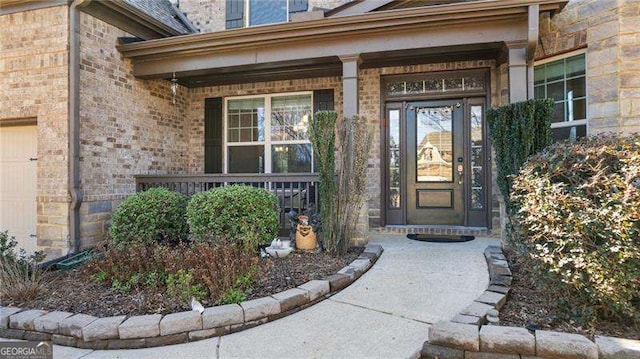 property entrance featuring brick siding and covered porch