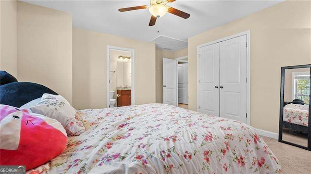 bedroom featuring a ceiling fan, a closet, connected bathroom, carpet, and baseboards