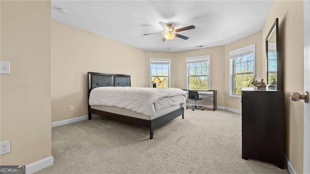 carpeted bedroom featuring baseboards and ceiling fan