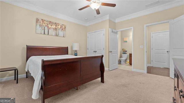 carpeted bedroom with baseboards, a ceiling fan, ensuite bath, and crown molding