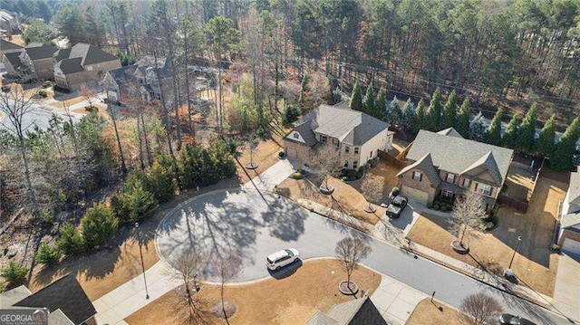 birds eye view of property featuring a residential view and a wooded view