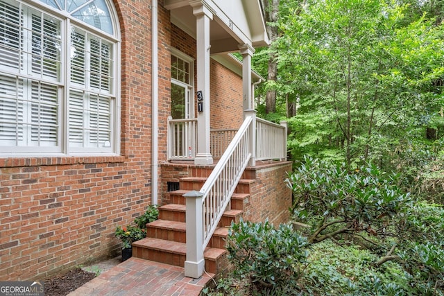 entrance to property featuring brick siding