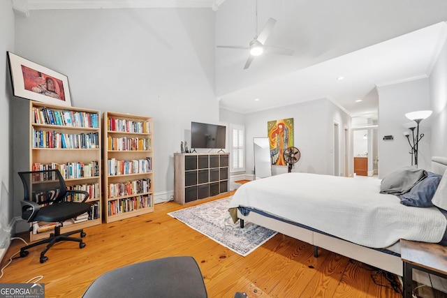 bedroom with recessed lighting, crown molding, and wood finished floors