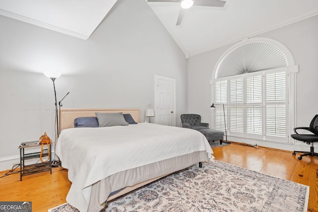 bedroom featuring crown molding, a ceiling fan, wood-type flooring, and high vaulted ceiling