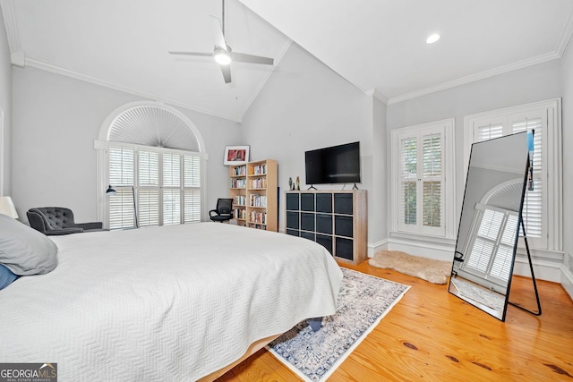 bedroom featuring light wood finished floors, vaulted ceiling, and ornamental molding