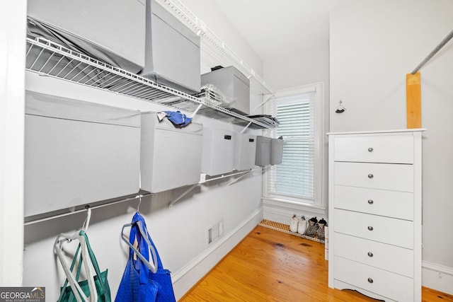 spacious closet with visible vents and wood finished floors