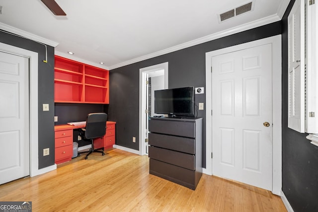 office with a ceiling fan, visible vents, light wood finished floors, and ornamental molding