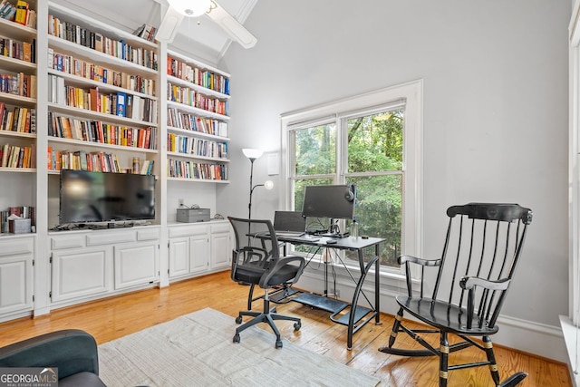 office featuring high vaulted ceiling, light wood-style flooring, baseboards, and a ceiling fan