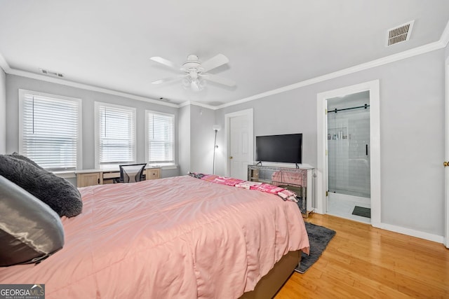 bedroom with light wood finished floors, visible vents, crown molding, and baseboards