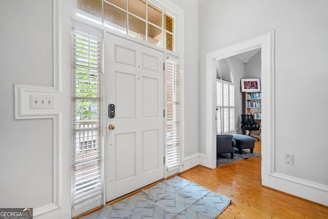 entryway with baseboards, light wood-type flooring, and a wealth of natural light