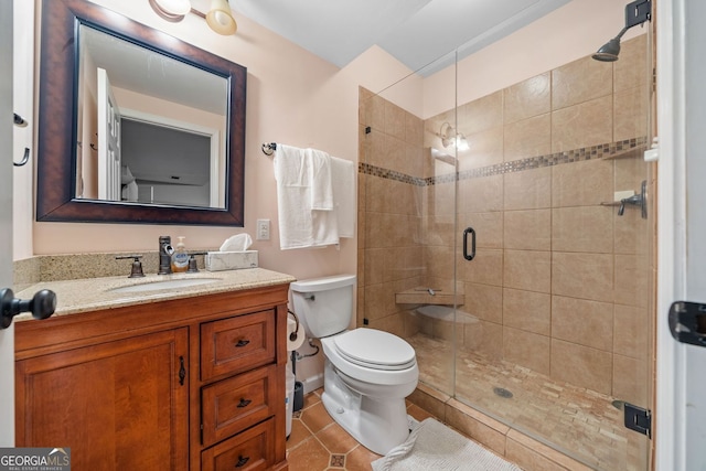 bathroom featuring vanity, toilet, a stall shower, and tile patterned flooring