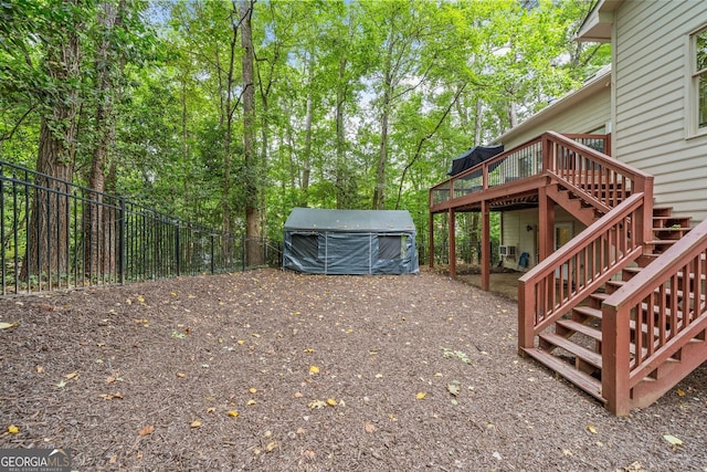 view of yard with stairs, a deck, and fence