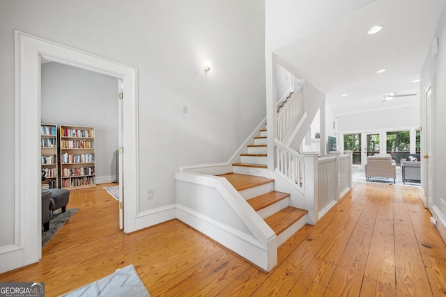 staircase featuring recessed lighting, baseboards, wood-type flooring, and ceiling fan