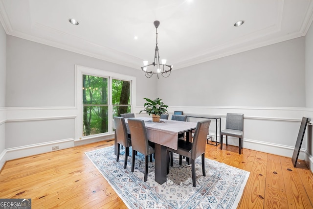 dining room with hardwood / wood-style flooring, ornamental molding, recessed lighting, and a chandelier