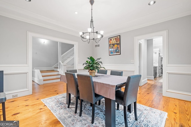 dining area featuring stairs, an inviting chandelier, visible vents, and ornamental molding