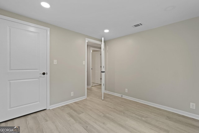 unfurnished bedroom with light wood-style floors, baseboards, and recessed lighting