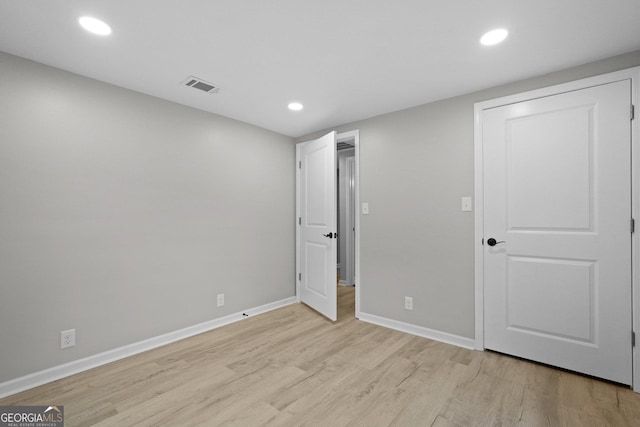 unfurnished bedroom featuring light wood-type flooring, baseboards, and recessed lighting