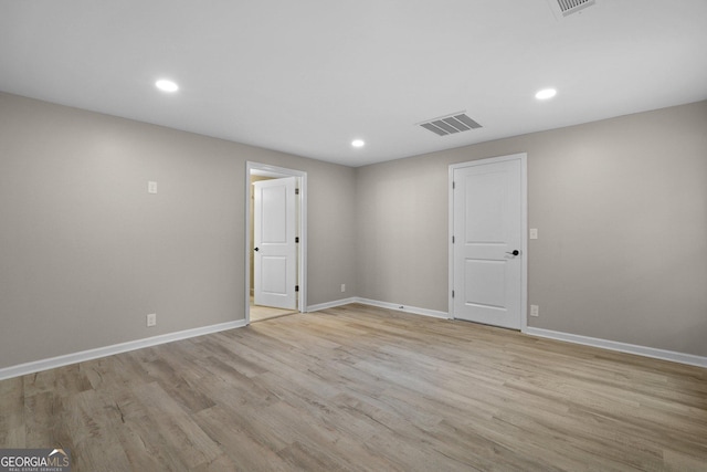 below grade area with light wood-type flooring, baseboards, and recessed lighting
