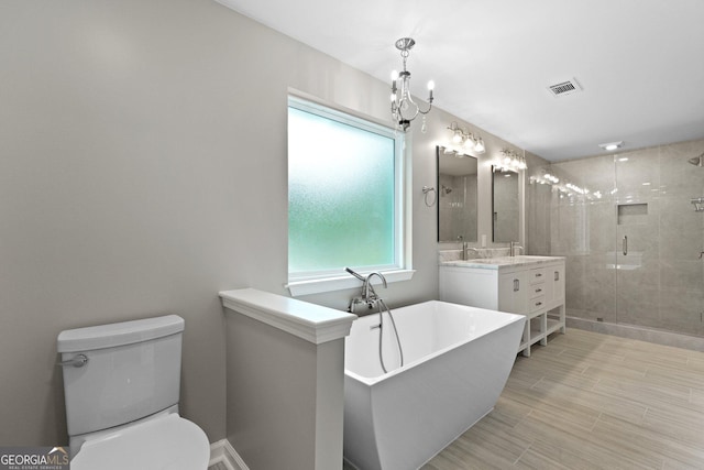 bathroom featuring a shower stall, toilet, vanity, and a soaking tub