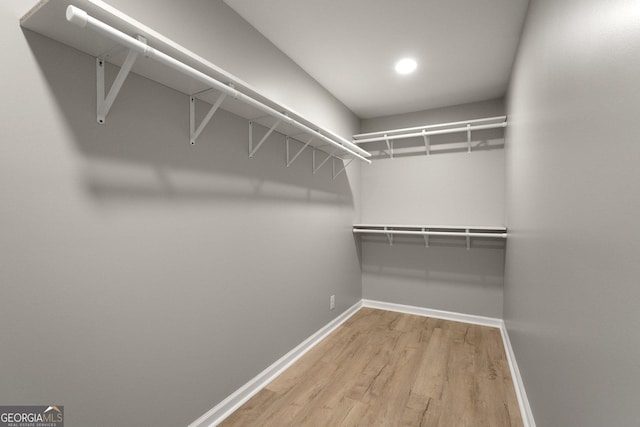spacious closet with wood finished floors