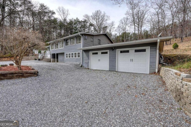 garage with gravel driveway